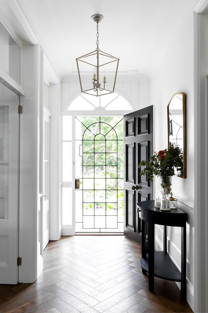 **ENTRANCE HALL** Both front doors are original to the house, and Laura gave the timber a handsome coat of [Dulux Black](https://www.dulux.com.au/colours/details/287705_8234|target="_blank"|rel="nofollow"). A lantern pendant emits a welcome glow, and a vintage table, painted in Taubmans Trendy, fits perfectly into the scheme.