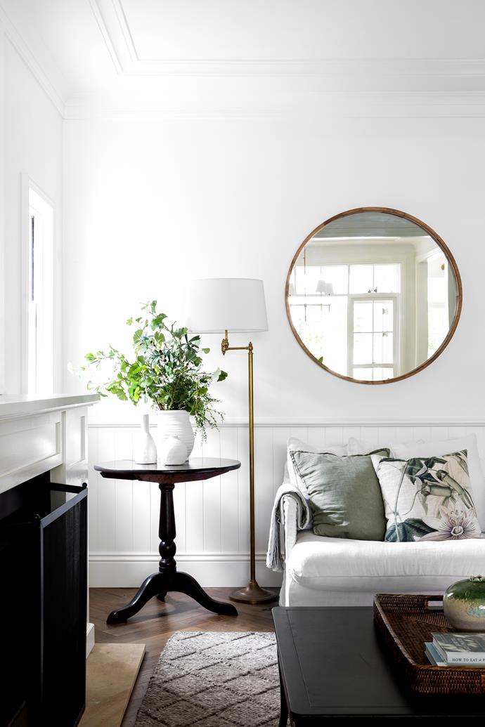 In the lounge, a [Uniqwa Collections](https://uniqwacollections.com.au/|target="_blank"|rel="nofollow") sofa anchors the space while the Emac & Lawton floor lamp and circular mirror form a subtle statement and connect to antique brass accents used elsewhere in the home.