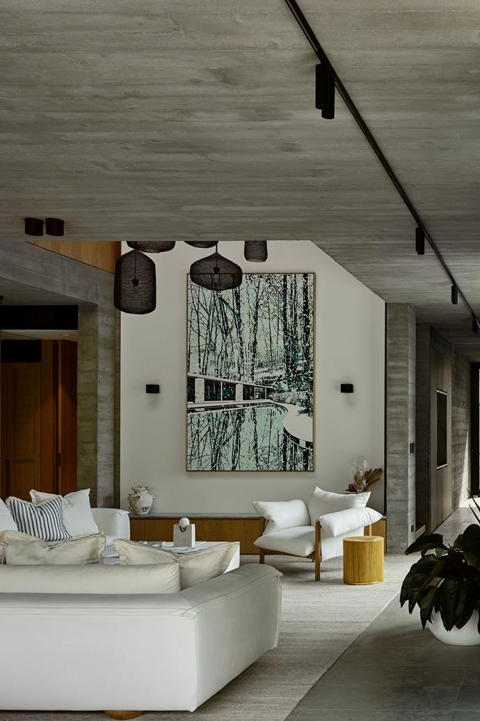 Artwork by Paul Davies in the living area. 'Sunny' modular sofas and 'Wilfred' armchair from Jardan, 'Kit Kat' hand-carved limestone coffee table from denHolm and ['Freddie' side table](https://www.dwr.com/living-side-end-tables/freddie-side-table/2537521.html?lang=en_US|target="_blank") from Sarah Ellison, all on a [rug from Armadillo](https://armadillo-co.com/product/odessa/|target="_blank"|rel="nofollow").