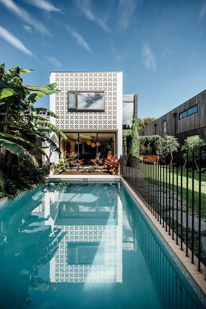 An inviting [swimming pool](https://www.homestolove.com.au/best-backyard-pools-17823|target="_blank") lines the length of the garden.