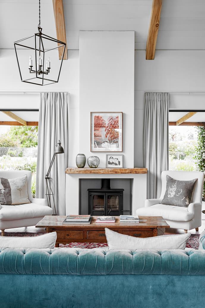 A reclaimed timber mantelpiece adds warmth and texture to the living room.