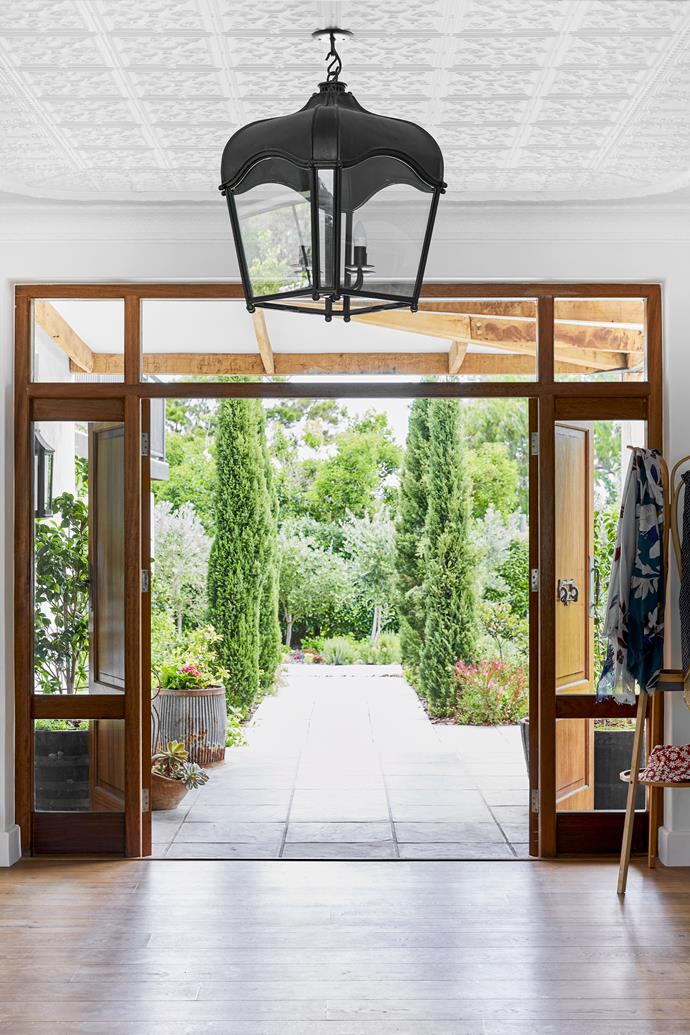 A contemporary version of a traditional farmhouse entrance greets visitors.