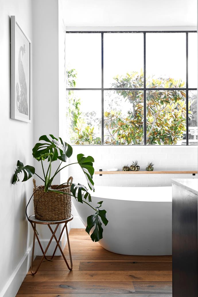 **ENSUITE** The couple's bathroom is a clean-lined, minimalist zone that, in keeping with the rest of this welcoming home, brims with natural light and greenery (try Temple & Webster for a similar basket).