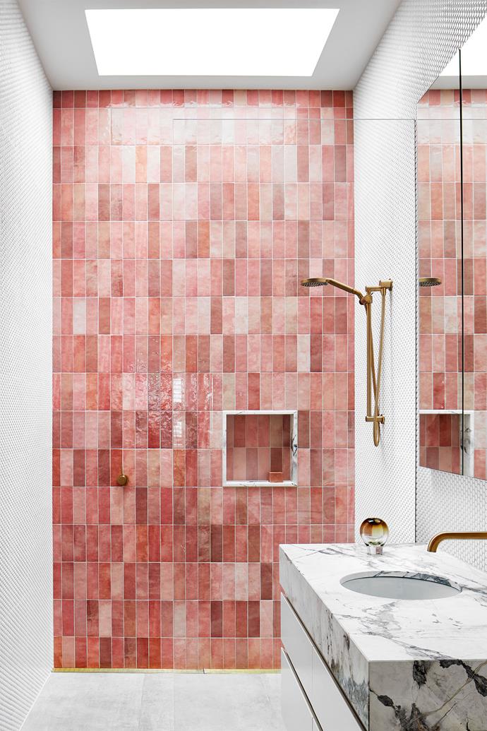 A child's ensuite features pink textured subway tiles and white penny round tiles from Byzantine Design. Vanity in Dulux 'Natural White' with Cote D'Azur marble top and 'Nordic' tapware. Vessel from Jardan.