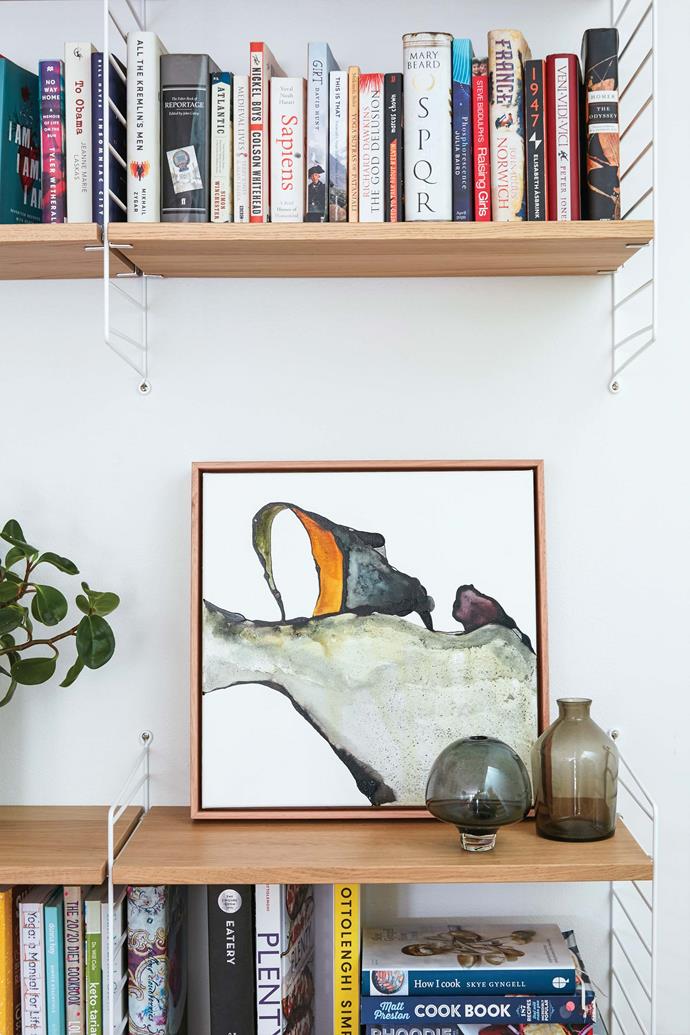 Some of the family's books and accessories are kept on a String shelving system from [Great Dane Furniture](https://greatdanefurniture.com/|target="_blank"|rel="nofollow"). Artwork, stylist's own.