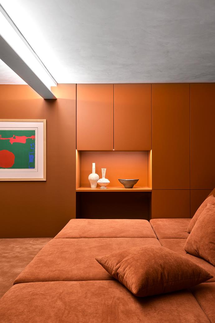 In the cinema room, custom seating in an Elliott Clarke fabric and custom cabinetry, both by Tobias Partners. Vases by Tetsuya Ozawa from The DEA Store. Bowl from Planet. Artwork by Patrick Heron.