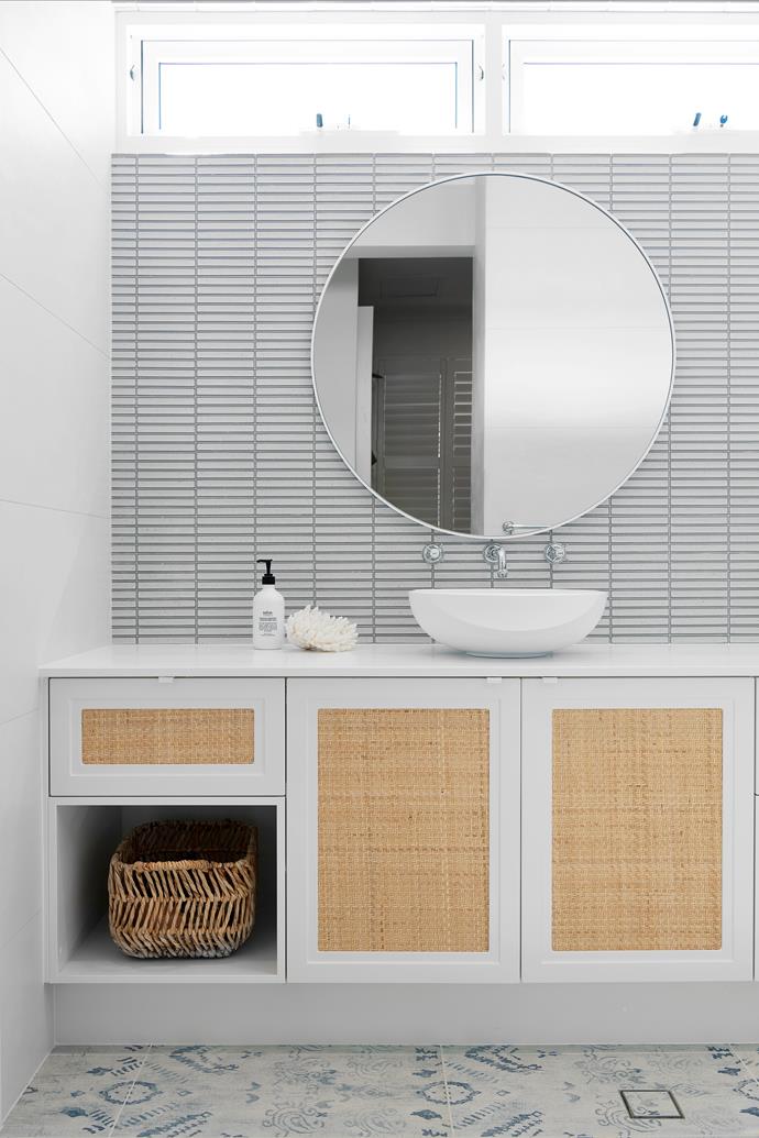 **ENSUITE** [Kit-Kat finger mosaics](https://www.homestolove.com.au/finger-tile-bathroom-ideas-22564|target="_blank") in Vintage Blue White were mounted horizontally to give the room width, and the 'Fusion Blue India' floor tiles from Myaree Ceramics, are an interplay of colour and pattern. "This tile is my favourite tile ever and also features on the edge of the pool," says Kristie. A 'Dylan' mirror from Freedom, Brodware 'Neu England' tapware, the Merwe above-counter basin from Sea Of White, a benchtop in Caesarstone London Grey and custom vanity with rattan inserts "for a beachy look" all lend a casual, relaxed air in this space.