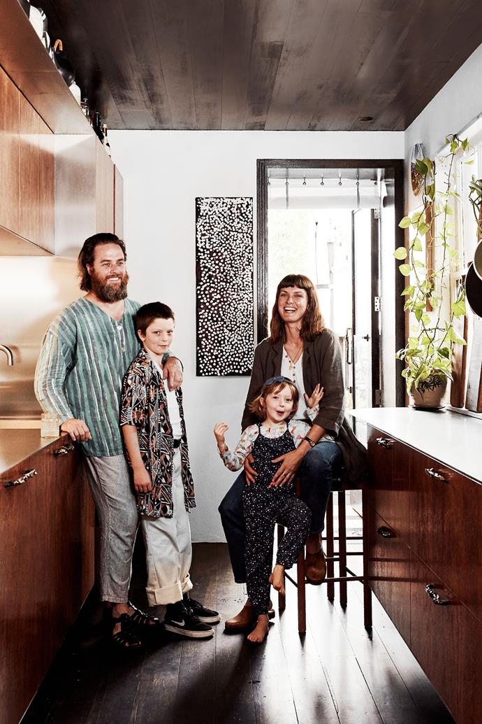 Artists James Drinkwater and Lottie Consalvo with their children Vincenzo and Hester in their compact home, a jewel beside the beach in Newcastle, NSW. Artwork by Johnny Warangkula Tjupurrula.