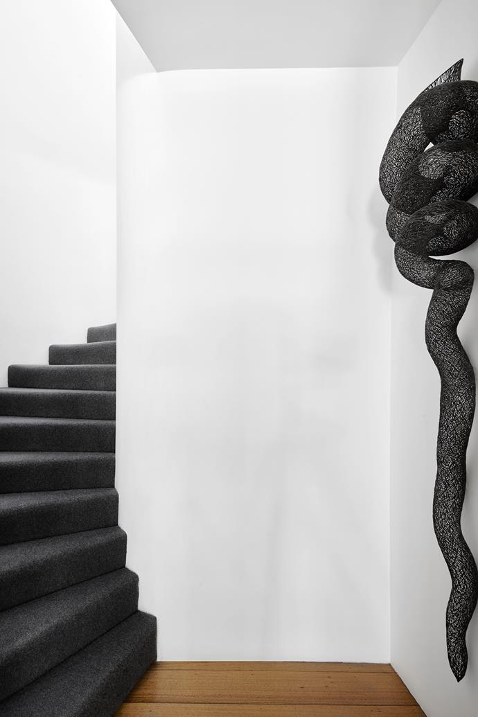 At the base of the stairs, which lead to the bedrooms and Andrew's office, hangs Rouleau, 2002, by Bronwyn Oliver.