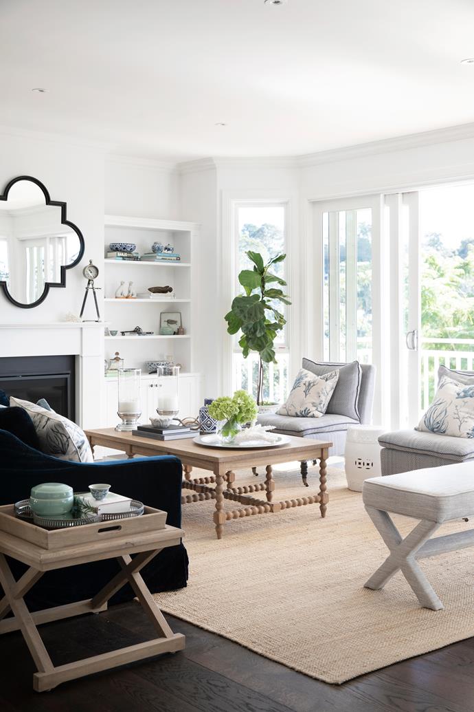 Charming and calming, this Hamptons-style living room, which features a palette of navy and cool greys against a dark timber floor, is a gathering space for the family who live in this [home in Sydney's north](https://www.homestolove.com.au/gracious-hamptons-home-sydney-23521|target="_blank"). Being on the top floor of the property, this space takes full advantage of the breathtaking views beyond.