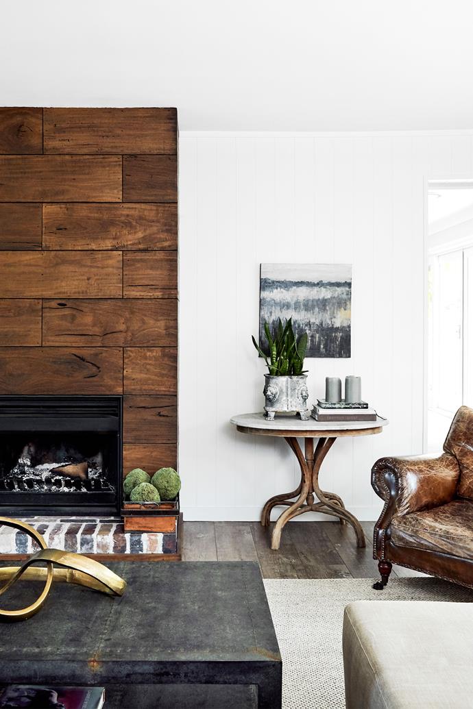The chimney breast is clad in blackbutt boards salvaged from the old stables. Painting by Angus Lockhart. The side table previously belonged to Jo's mother. Coffee table, Zaffero. Leather armchair, Bisque Traders. Sisal rug, Unitex.