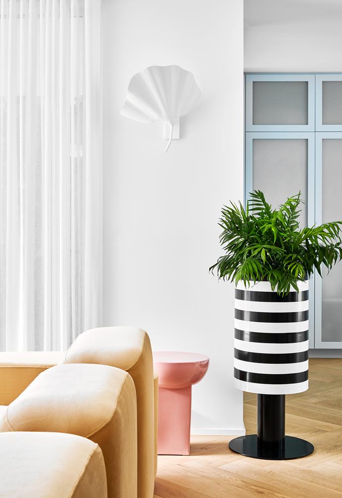 A monochrome striped plant holder by Studio Ciao is both functional and decoratively playful.