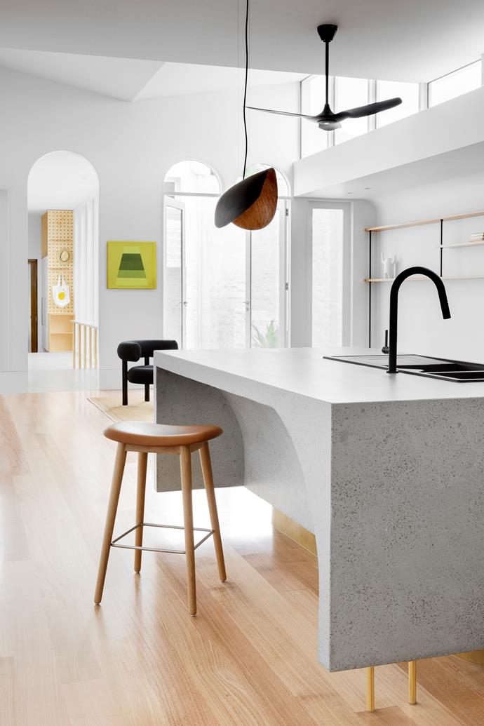 The kitchen features stainless steel and concrete benchtops, Green Tapware matte black sink mixer and a Franke double bowl sink. Timber flooring adds warmth to the scheme without visually competing with the pops of colour.