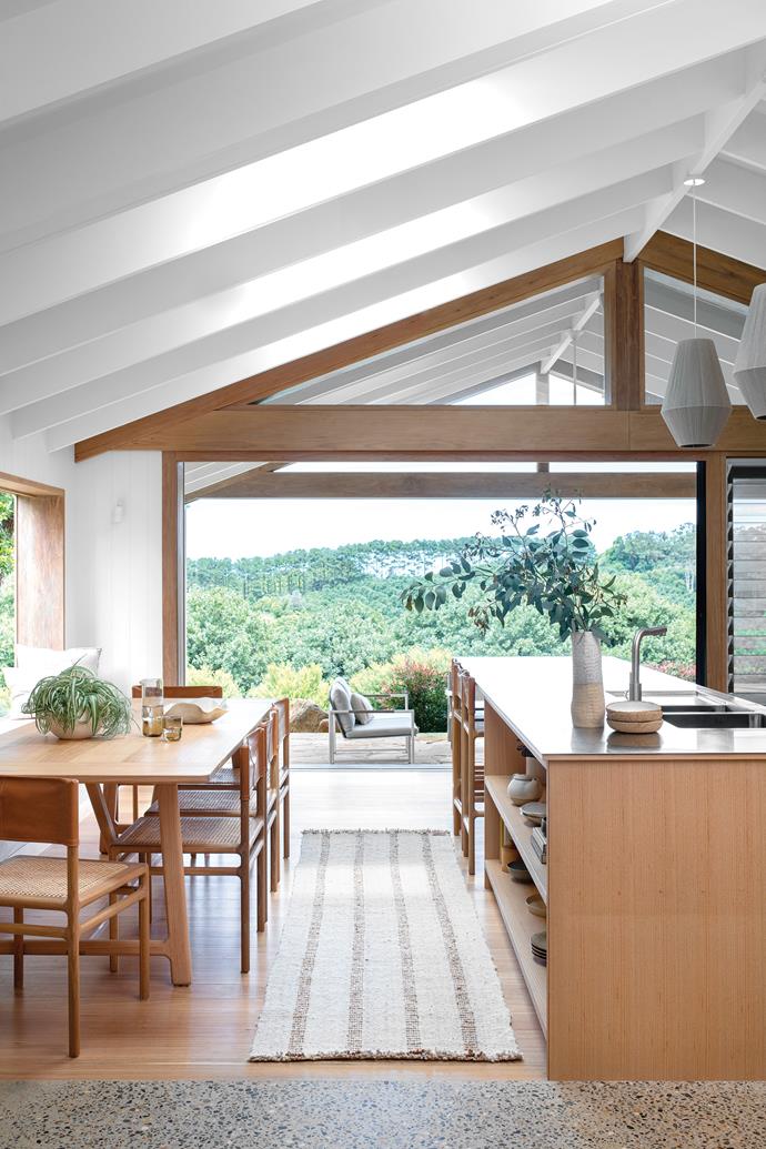 A connection to the outdoors was a strong consideration for the owners of this [low-tox home in Byron's hinterland region](https://www.homestolove.com.au/sustainable-home-byron-hinterland-23565|target="_blank"). In the kitchen and dining area, it's achieved through a continuation of the ceiling and the inclusion of large doors, louvered windows and a window seat.