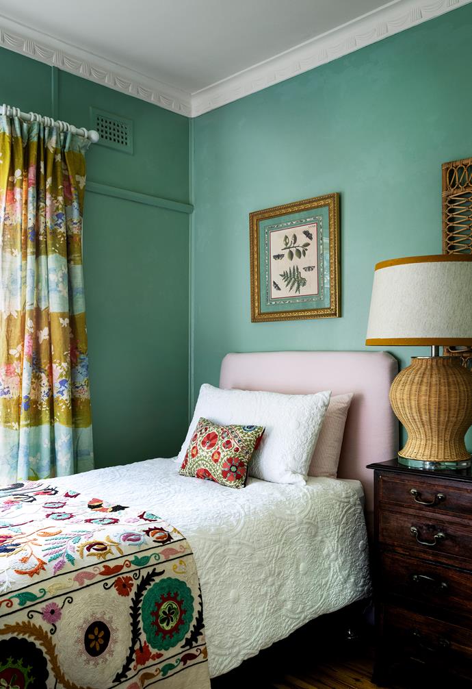In the guest room, a suzani quilt from Uzbekistan sits alongside vintage curtains.