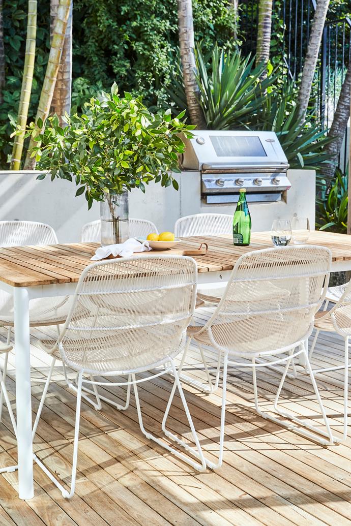Surrounded by verdant foliage, the outdoor area is perfect for entertaining.