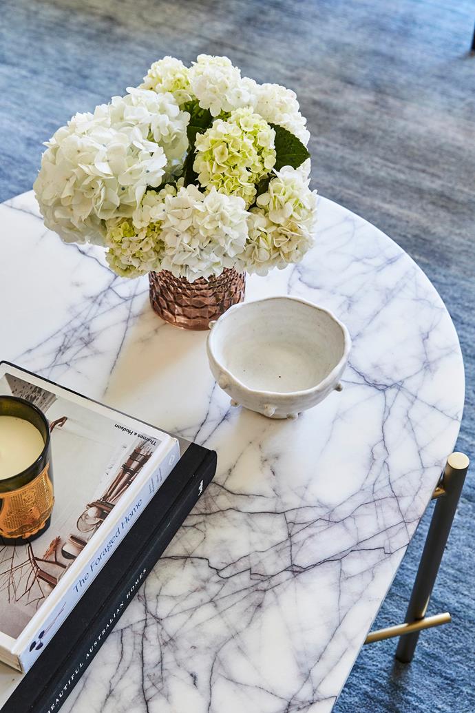 The marble-topped 'Elle Pipe' coffee table from [Globe West](https://www.globewest.com.au/|target="_blank"|rel="nofollow") - an elegant surface for Lauren's ornaments.