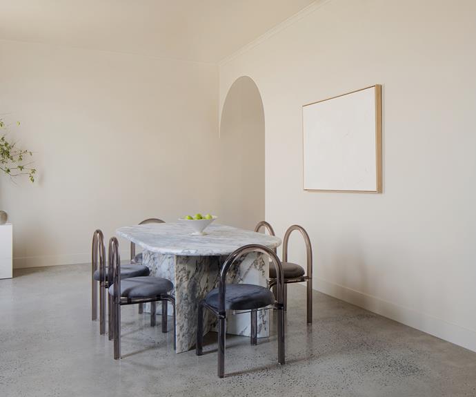 Balance between light and dark elements is achieved thanks to the pairing of the Sienna stone table and Daisy chairs in Smokey. On show here is Salt and Stone Pt. 4 artwork by White on Walls, [Fossil limestone plinths](https://engold.com.au/products/fossil-limestone-plinth|target="_blank"|rel="nofollow"), [Pila vessel](https://engold.com.au/products/pila-vessel|target="_blank"|rel="nofollow") and Lucite Orb, all from En Gold.