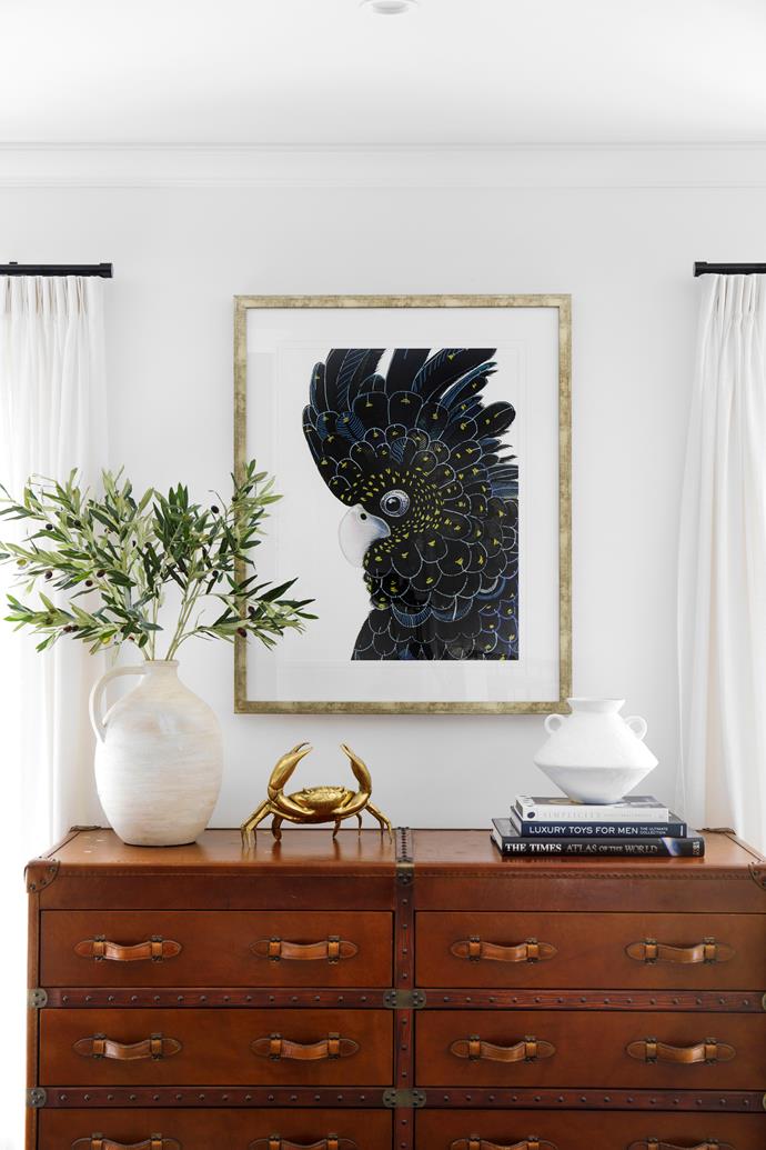 **LIBRARY** Josephine discovered the tan chest of drawers at a vintage store and uses it to house the family's collection of board games. On the wall, a Yanbury Bird VI artwork from [Designer Boys](https://www.designerboysart.com/landing/|target="_blank"|rel="nofollow") commands attention.