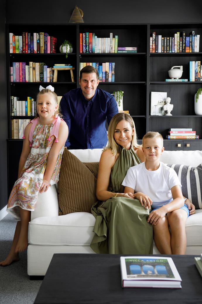 Sofia, Bryant, Josephine and Michael pictured in the home's library, which is painted in Dulux Black Caviar.