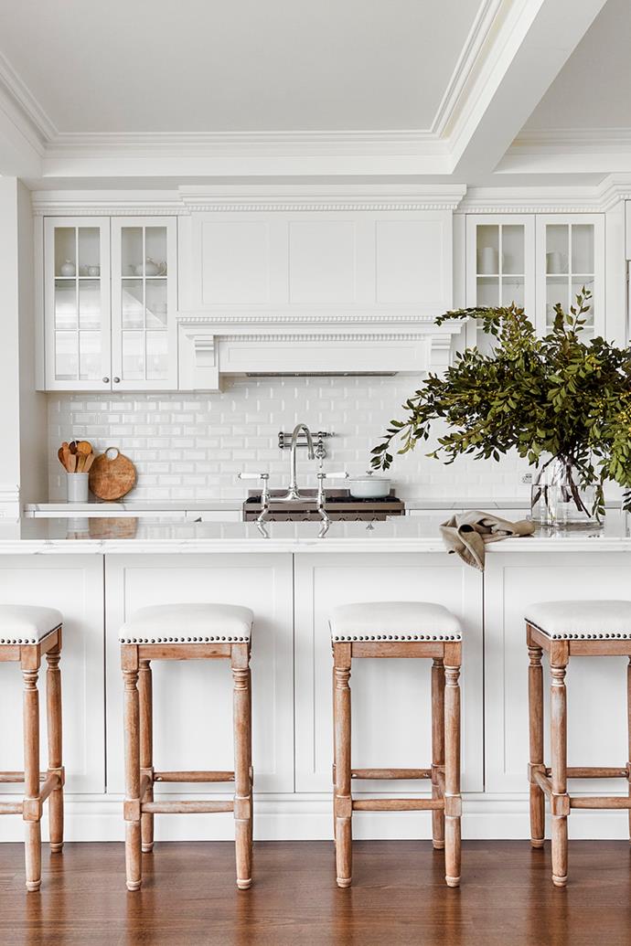 **KITCHEN** "It's all about the details," says Jody of her all-white kitchen, made by [Cobbitty Grove Kitchens](https://www.cobbittygrove.com.au/|target="_blank"|rel="nofollow") in Polytec and finished in Dulux Lexicon Quarter. "The dentil cornice along the top of the cabinets and around the extractor fan broke the budget, but I loved it so much I had to have it." A go-to for Hamptons vibes, the generous kitchen island boasts stately columns and a Statuario Venato benchtop from [Smartstone](https://www.smartstone.com.au/|target="_blank"|rel="nofollow") with double ogee edge. Brosa 'Clovis' bar stools echo the armchairs in the adjacent lounge, while Chasseur accessories bring a touch of duck egg blue. Simple and refined, the 'Vine' white bevel gloss tiles from Beaumont Tiles allow the architectural details to shine. The much-used pot filler is from Restoration Online.