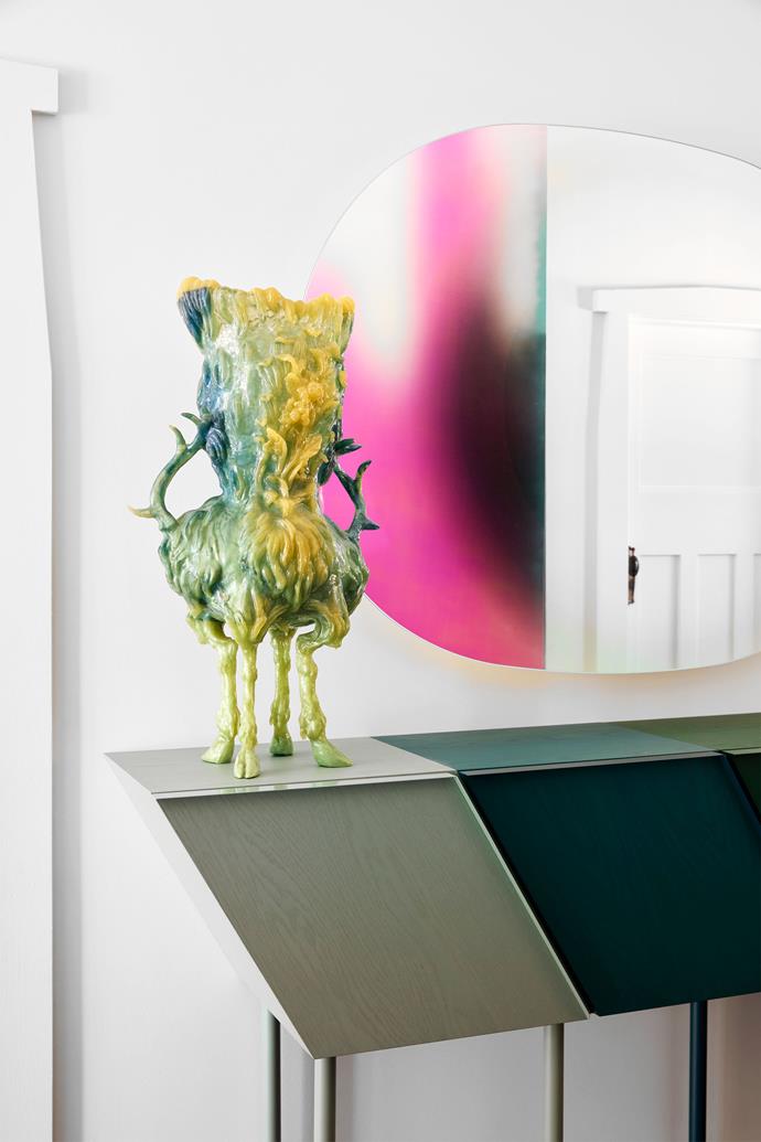 In the hallway, a Kate Rohde sculpture on a 'Chromatic Fantastic' console by Danielle Brustman. Ry David Bradley's AA16 is reflected in the Glas Italia 'Shimmer' mirror from 1stdibs.