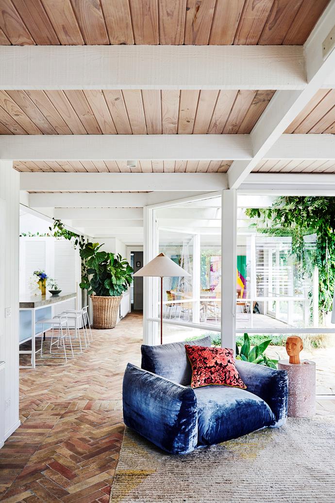 Artist Prudence Oliveri's ["mid-century modern inspired" home](https://www.homestolove.com.au/prudence-olivieri-home-21346|target="_blank") is brought to life with art, colour and textures, including a rustic original brick floor. The unique patina of the bricks brings a certain charm to the space, which she describes as a joyful place to live.