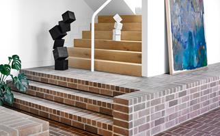 room with brick floors leading up staircase