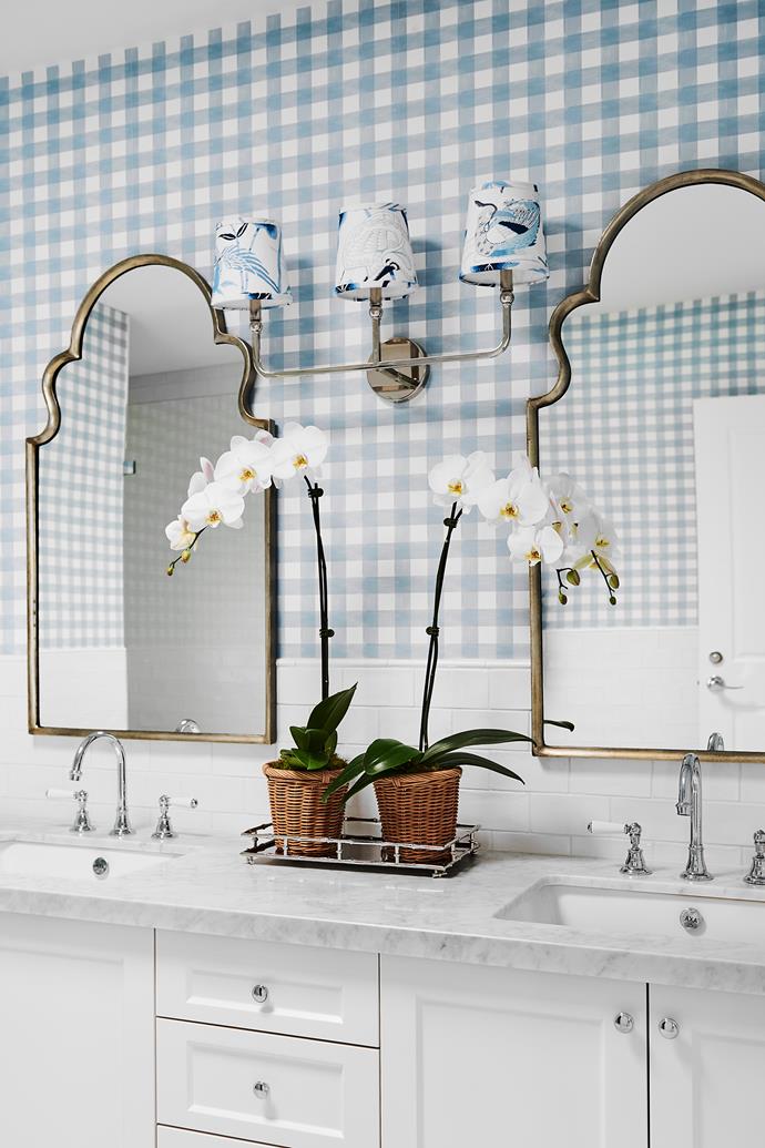 **ENSUITE** Gingham-style 'Check' wallpaper in Dusty Blue by Bethany Linz from [Milton & King](https://www.miltonandking.com/|target="_blank"|rel="nofollow") balances the same vanity, tiles and tapware finishes used in the powder room. For a similar arched wall mirror, try the Uttermost selection at Shine Mirrors.