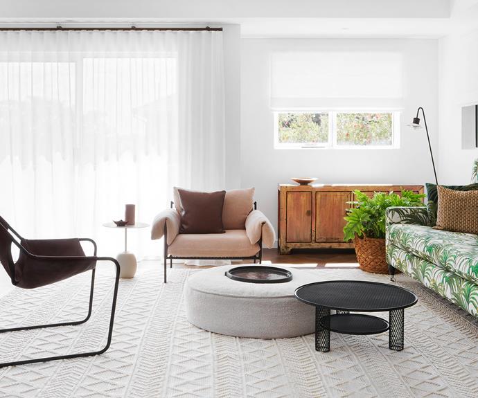 Beverley's existing sofa was re-covered in a tropical print fabric – it and the timber sideboard are among the few pieces she kept. The Sarah Ellison 'Alva' armchair from Life Interiors adds a feminine sense. In the centre of the room, the &Tradition 'Lato' side table from Cult and a GlobeWest ottoman create contrast beside the Moroso 'Net' coffee table from Hub Furniture.