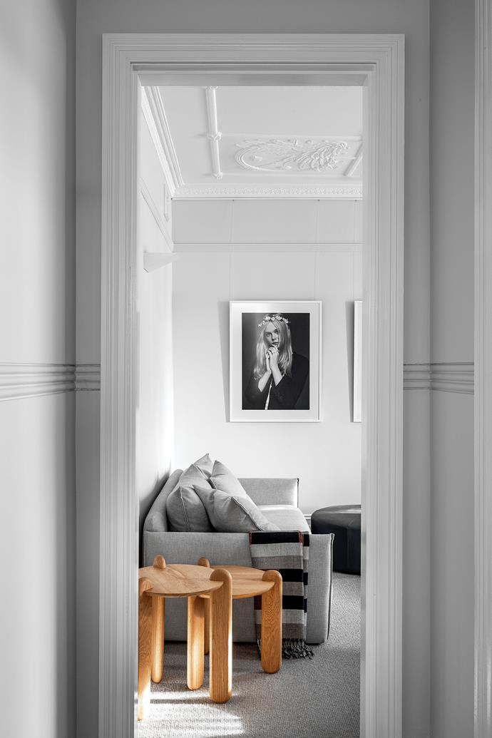 The black and white photographs are by Karl Lagerfeld. Oure 'Pop' side tables, Koskela. Sofa and round ottoman, both Studio Pip. The interior doors are painted in Porter's Paints 'Alpine'.