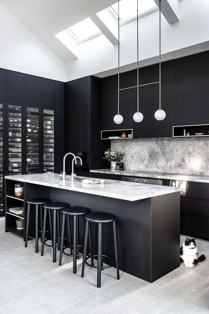 Minty the rescue cat in the kitchen, where wine storage and lots of bench space were the main priorities. Tesrol Super cleanlaminate joinery by Bespoke Joiners. Dogal Dark Grey marble bench tops and splashback, Surface Gallery. Wine cabinet custom designed by Studio P.
