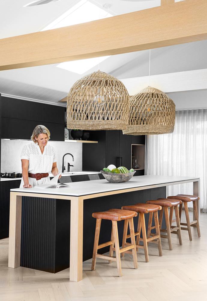 "I love this space," says Anna (pictured). "It's so easy to work in; the drawers and cupboards are powered so they open with a light touch. It also has a view of the sea out the front and palm trees out the back." The cabinetry is handpainted in black with custom panelled grooving, and the island frame is limewashed American oak. Dekton 'Lunar' benchtops, [Cosentino](https://www.cosentino.com/en-au/|target="_blank"|rel="nofollow"). [Gessi](https://www.gessi.com/|target="_blank"|rel="nofollow") 'Emporio' tapware. Bar stools, [McMullin & Co](https://www.mcmullinandco.com/|target="_blank"|rel="nofollow"). Oven and cooktop, [V-Zug](https://www.vzug.com/au/en/|target="_blank"|rel="nofollow"). Pendant lights, [SmithMade](https://www.smithmade.com.au/|target="_blank"|rel="nofollow"). James Dunlop 'Kyoto' curtains, [Marlow & Finch](https://www.marlowandfinch.com.au/|target="_blank"|rel="nofollow").