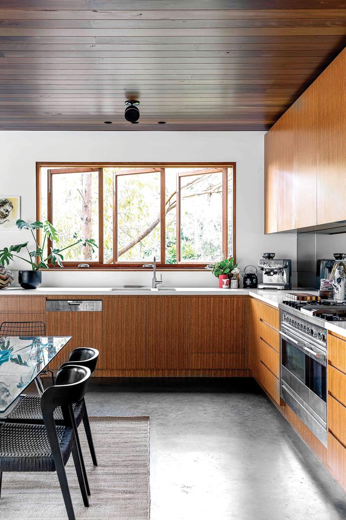 **KITCHEN:** Spotted-gum veneer on [the cabinetry](https://www.homestolove.com.au/kitchen-cabinet-door-styles-7021|target="_blank") complements the home's other timber elements. The grand piano is close by, so Alexandra decided not to have an island bench in the space as well. "The kitchen is a dog-leg shape and designed so I can stand in one spot and reach the sink, prep area and oven," she says. A [butler's pantry](https://www.homestolove.com.au/butlers-pantry-design-ideas-17450|target="_blank") keeps mess from view.