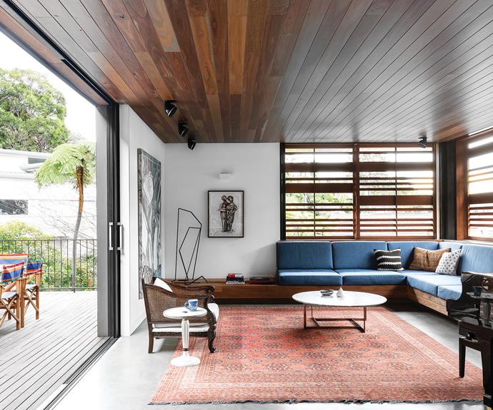 **LIVING AREA:** A built-in sofa and grand piano define the space, which is used for large gatherings. Persian rug on concrete floor. Coffee table, [Poliform](https://www.poliformaustralia.com.au/|target="_blank"|rel="nofollow"). Vintage rattan armchair, [Lawsons](https://www.lawsons.com.au/|target="_blank"|rel="nofollow"). Artworks by Alexandra and Carlos Barrios (charcoal). Sculpture by Jenny Herbert-Smith.