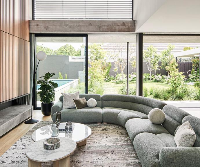 "In this double-height, open-plan space," says architect Berit Barton, "your eye is immediately cast to the garden, where a hard and soft landscape interacts with the interior through a shared finishes palette of timber and concrete." A [Jardan](https://www.jardan.com.au/|target="_blank"|rel="nofollow") 'Valley' couch introduces more curves and, perhaps more importantly, enough space for the whole family to relax.