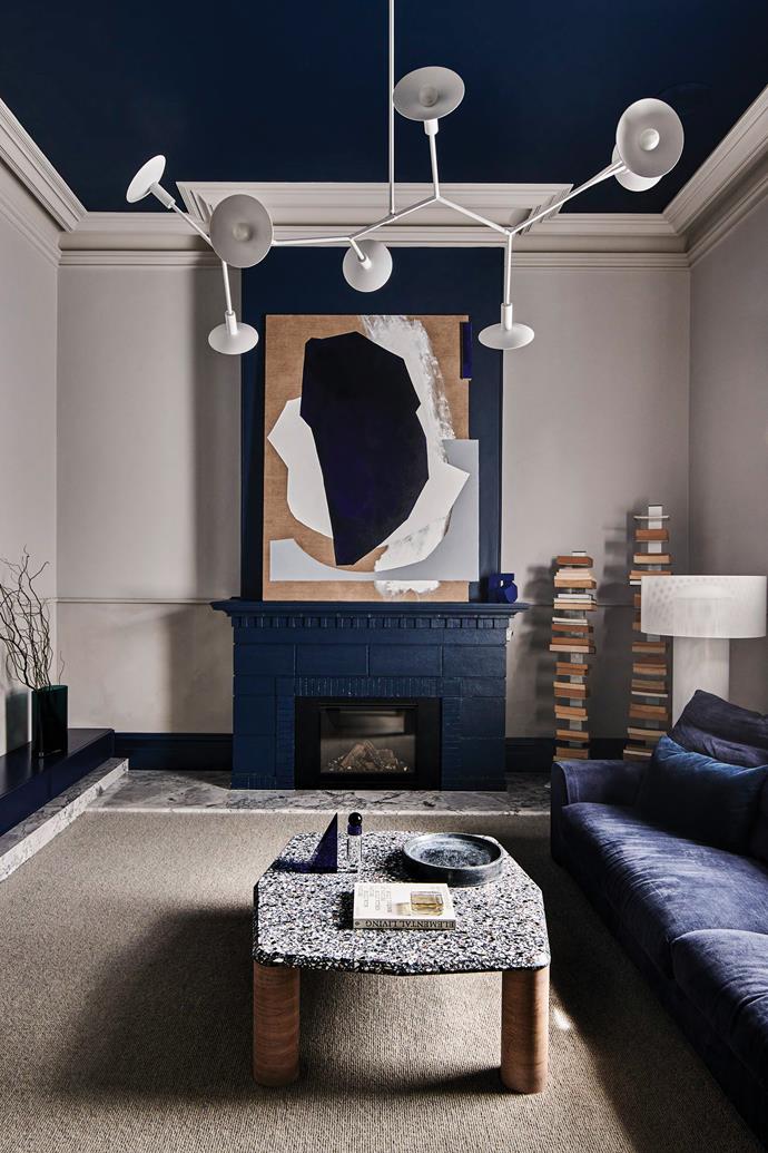 In comparison to Sarah's room, the room next door is very much Peter's domain. It has a more masculine, moody feel. Blue modular sofa, [Jardan](https://www.jardan.com.au/|target="_blank"|rel="nofollow"). Grey walls, [Dulux](https://www.dulux.com.au/|target="_blank"|rel="nofollow") Dieskau. Ceiling, [Dulux](https://www.dulux.com.au/|target="_blank"|rel="nofollow") Pacific Line. Branchflower pendant, [Giffin Design](https://www.giffindesign.com/|target="_blank"|rel="nofollow"). Artwork by Ben Sheers, through [Otomys](https://otomys.com/|target="_blank"|rel="nofollow").