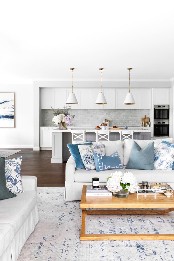 **LIVING** Almire has curated a [coastal Hamptons vibe](https://www.homestolove.com.au/classic-modern-home-queensland-22193|target="_blank") by styling the linen-look sofas from Plush (one of the first furniture purchases she made for the home) with a 'Sicily' oak coffee table from Provincial Home Living, a vintage-look rug from [Style My Home](https://www.stylemyhome.com.au/|target="_blank"|rel="nofollow") and soft blue cushions from Hamptons Style.