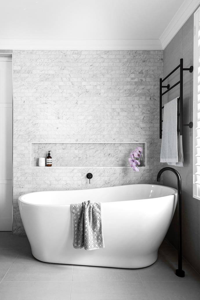 **ENSUITE** An expanse of classic 'Navona Ice' marble subway tiles from Beaumont Tiles make a statement here, incorporating a [handy niche](https://www.homestolove.com.au/walk-in-showers-21163|target="_blank") for bath products. A sculptural Caroma 'Blanc' freestanding bath, and black 'Vivid Slimline' tapware and 'Radii' towel ladder, both by [Phoenix](https://www.phoenixtapware.com.au/|target="_blank"|rel="nofollow"), lend a modern twist to a spa-like retreat – which, admits Almira, doesn't get used as often as she'd like. "I need to make better use of it!" she says with a laugh. The 'Maximo White' floor tiles are also from Beaumont Tiles.