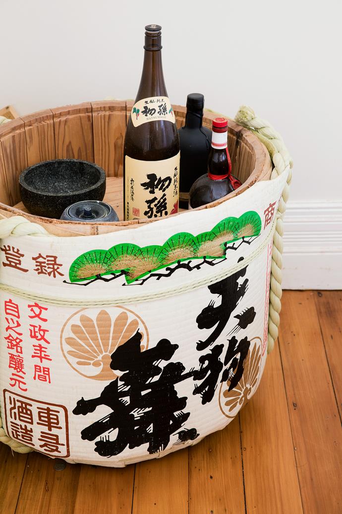 In one corner sits the sake barrel from their wedding, which they often repurpose as an [ice bucket](https://www.homestolove.com.au/bar-cart-essentials-18600|target="_blank"). "Instead of cutting a cake, a Japanese wedding has a ceremony called 'kagami biraki,' which is where a barrel of sake is smashed open with a wooden mallet," explains Adam. "The barrel itself was a gift from the sake brewery in my wife's home state of Ishikawa, as they are friends of our family."