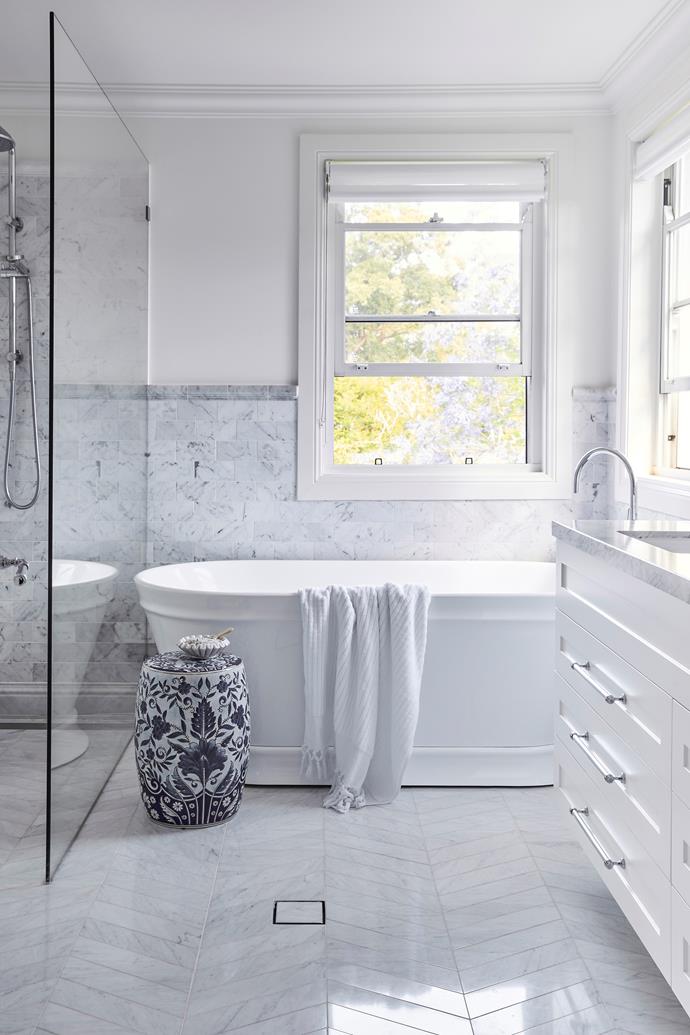 **ENSUITE** "In the ensuite we used long [Bianco Carrara](https://www.cdkstone.com.au/product/bianco-carrara/|target="_blank"|rel="nofollow") subway tiles in a chevron pattern on the floor and shorter, wider subways on the wall, both from Industrie Tapware," says Sarah. "Finishing the look with an edging tile is a lovely decorative detail similar to a dado rail."