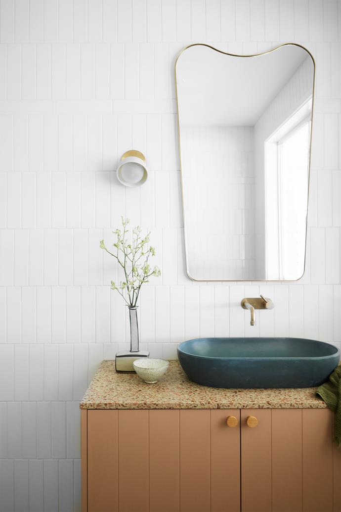 In the main bathroom, tiles and terrazzo benchtop from Onsite Supply & Design crown the joinery by Berecon. Yokato 'Roma' taps in bronze from Brodware. Wall light from Marz Designs.