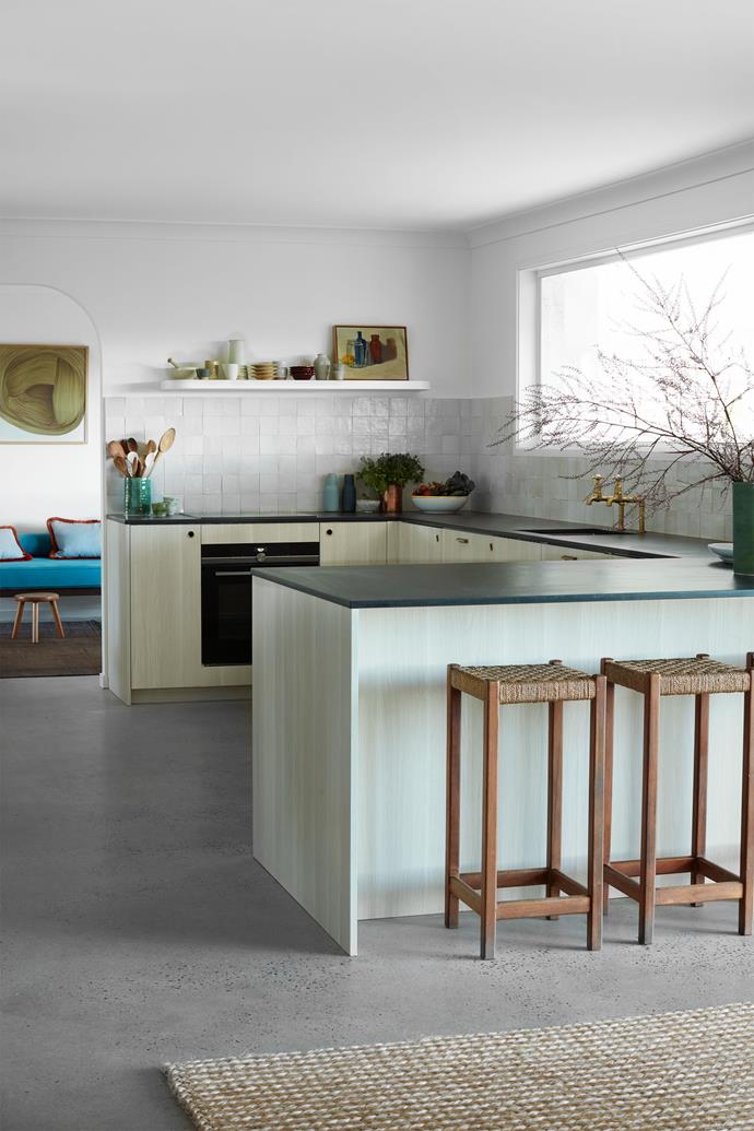 In the kitchen, new joinery by Ren Studio and benchtop and tiled splashback by Onsite Supply & Design contrast with vintage stools and artworks by Jim Moody.