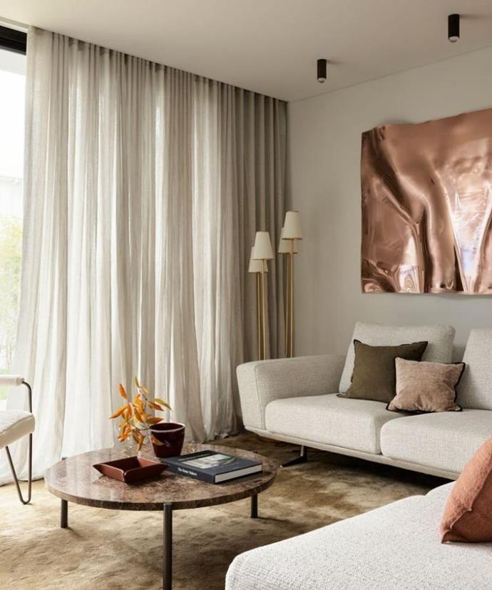 Statement floor lamps in the living room of this [Dover Heights home](https://www.homestolove.com.au/smac-studio-european-inspired-home-23641|target="_blank") transform one end of the [King Bellaire Sofa](https://www.kingliving.com.au/shop/living/sofas/bellaire|target="_blank"|rel="nofollow") into the perfect reading nook.
