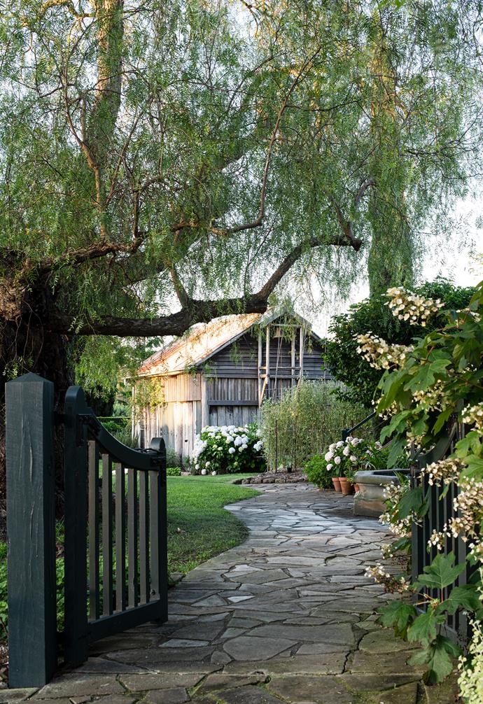 An [enchanting path](https://www.homestolove.com.au/garden-path-ideas-22484|target="_blank") leads to the barn.
