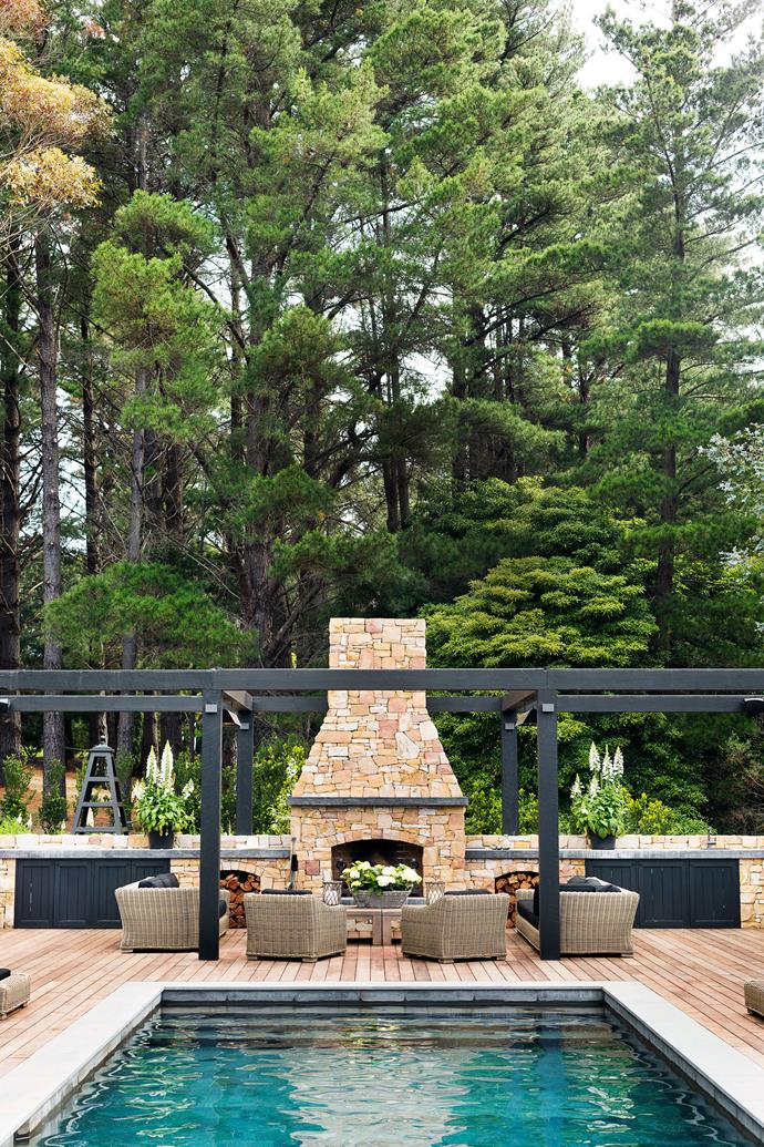 Real housewives know how to deck out an outdoor entertaining area as [Chyka Keebaugh's leafy Mornington Peninsula weekender](https://www.homestolove.com.au/mornington-peninsula-weekender-19583|target="_blank") demonstrates. The stone wall extends upwards to a central wood-burning outdoor fireplace which, while grand, is dwarfed by the surrounding tree canopy - just the way nature intended stone to be.