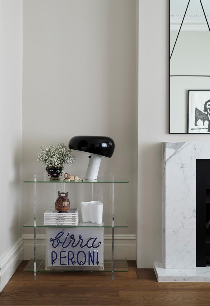 The items displayed on the Combiplex shelving from Fred International have been collected by homeowner and interior designer Olivia Giangrasso on her travels. There is a black ceramic head from Praiano in Italy, a lion bought in South Africa, objects from Lima in Peru, a vintage Peroni sign and a white Iittala vase. A black 'Snoopy' lamp by Flos completes the understated vignette.