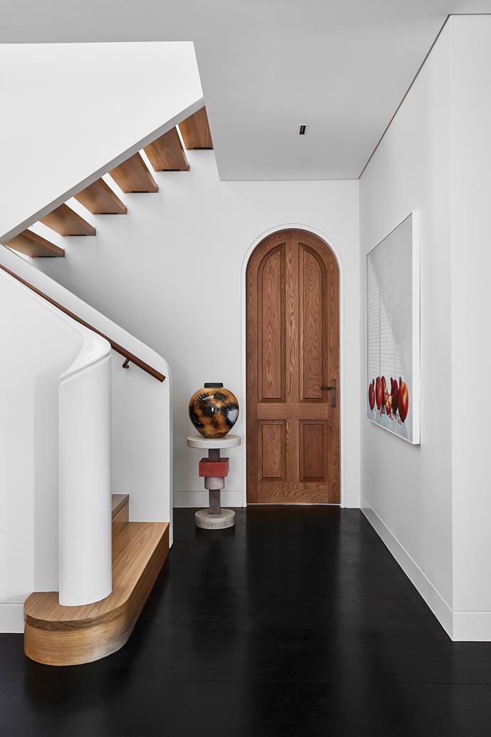 **STAIRCASE** This ground-floor landing shows off the polished black Japan floors. Dorothy side table, [Tow And Line](https://www.towandline.com/|target="_blank"|rel="nofollow"). Terra vase, [Becker Minty](https://www.beckerminty.com/|target="_blank"|rel="nofollow").