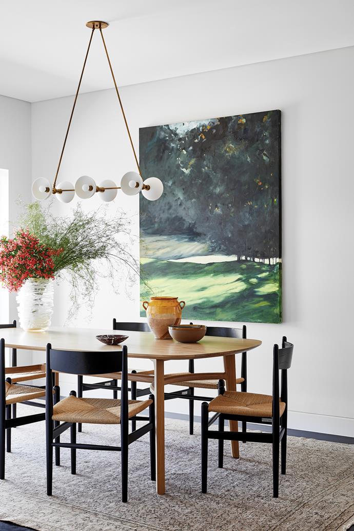 **DINING AREA** Carl Hansen & Søn 'CH36' chairs were chosen for the custom Trim table by [The Wood Room](https://thewoodroom.com.au/|target="_blank"|rel="nofollow"). Apparatus 'Trapeze' pendant light, [Criteria Collection](https://criteriacollection.com.au/|target="_blank"|rel="nofollow"). Murano glass vase, [Conley & Co](https://www.conleyandco.com/|target="_blank"|rel="nofollow"). Urn, [Parterre](https://www.parterre.com.au/|target="_blank"|rel="nofollow"). Serax ceramic bowl, [Spence & Lyda](https://www.spenceandlyda.com.au/|target="_blank"|rel="nofollow"). Marble bowl, [Greg Natale](https://www.gregnatale.com/|target="_blank"|rel="nofollow"). Artwork by Martine Emdur.