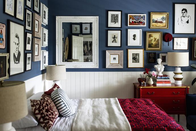 This second guest room is painted Taubmans Cape Blue. The artworks here are all precious finds collected over the years: "It's a real mix of childhood photos, gifts from friends – the male portraits are by Grant Cowan – and travel mementoes," says Neale. "There is even an original David Bromley in there – and the fez is from Morocco!" Flowers from Shady Fig.